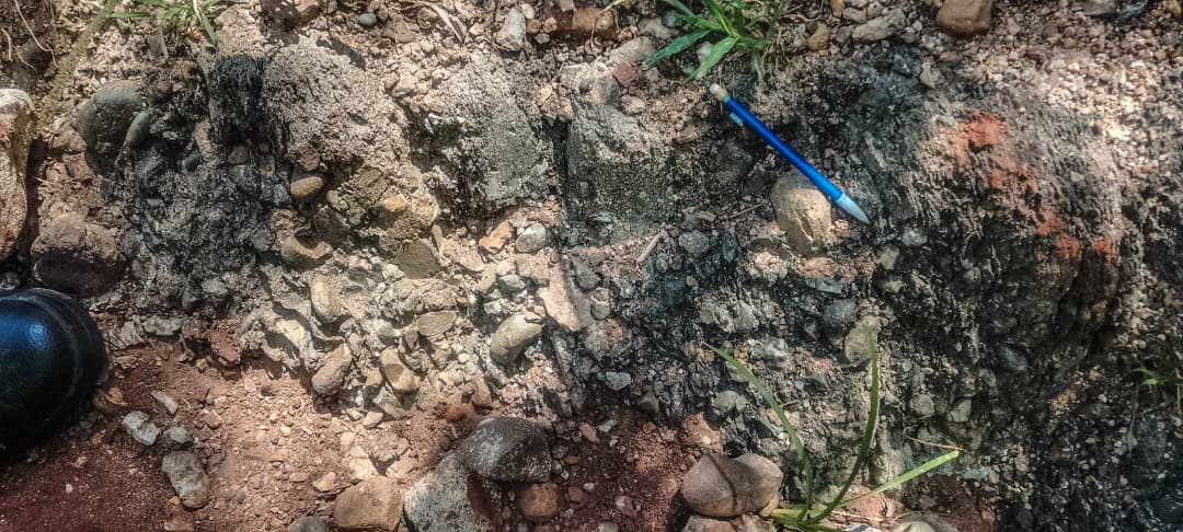 Geological exposure marked with a pencil for scale during Mberengwa exploration