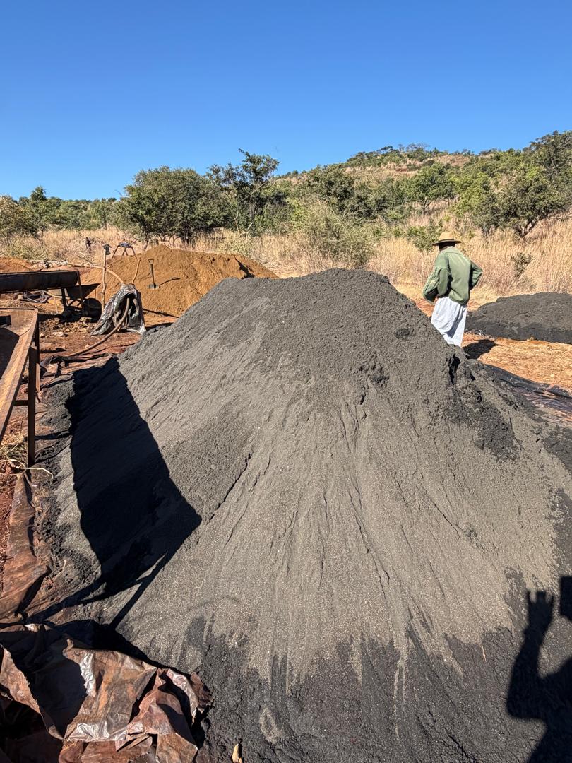Alluvial chrome material stockpile with field personnel at Mhondoro Ngezi