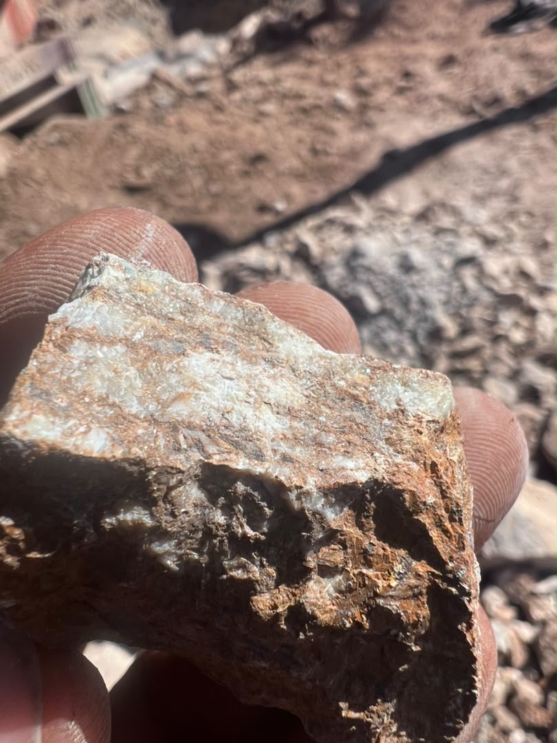 Close-up view of a rock sample held during geological assessment in Nyanga